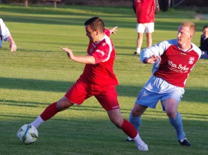 Ossett Town striker Rob Bordman turns away from Paul Sykes in the 1-1 draw with AFC Emley