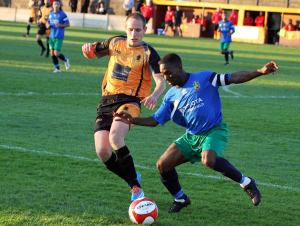 Ossett Albion striker Dale Kelly battles with Brighouse Town captain Leon Henry. Picture: Adam Hirst