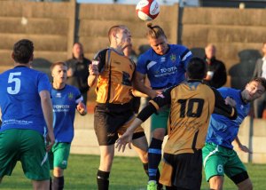 Hair-razing: Brighouse Town defender Adam Field wins the aerial battle in his side's 2-1 win at Ossett Albion. Picture: Adam Hirst