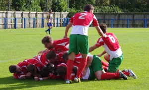 Pile-on: Harrogate Railway celebrate Adam Baker's winning goal with Lawrence Hunter acting as the pile-on co-ordinater