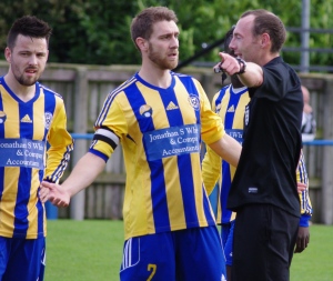 Referee Mark Dwyer receives the thoughts of Garforth captain Andy Hawksworth on the red card 