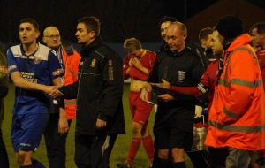 Referee David Benton is escorted off after declining Craig Elliott's handshake following the 1-1 draw between Farsley AFC and Ossett Town