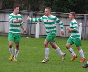Reece Chappell congratulates Tom Carr (centre) after his 62nd minute penalty 